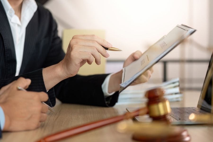 Legal Review. Lawyer discussing contract details with colleague.