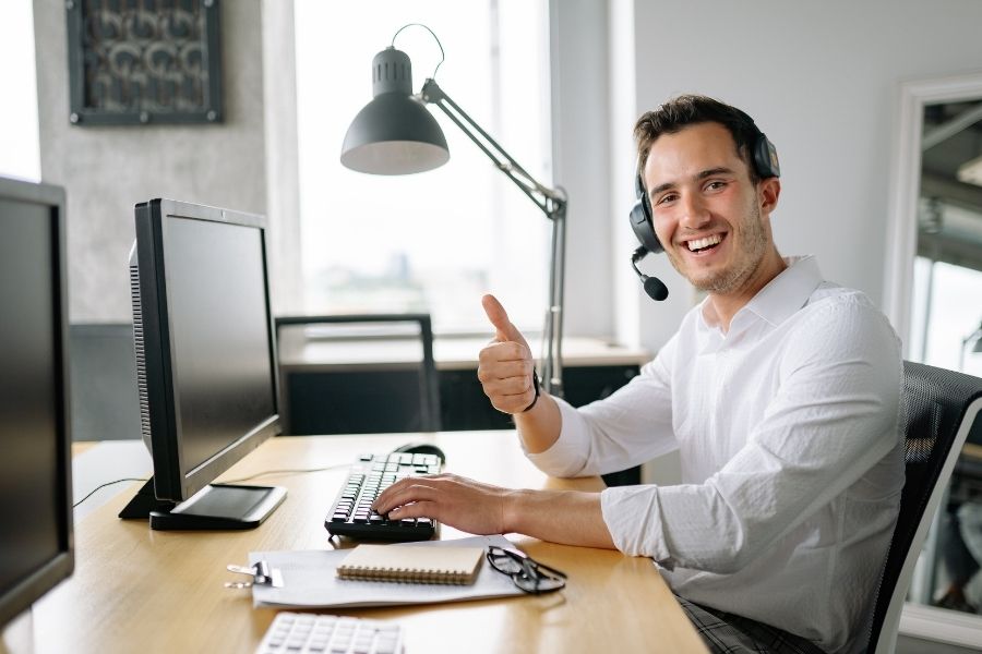 A Man Working in an Office while Wearing a Headset