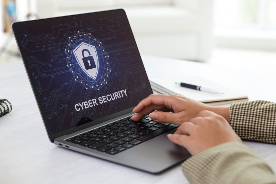 Cyber Security. Woman Using Laptop at Table, Closeup